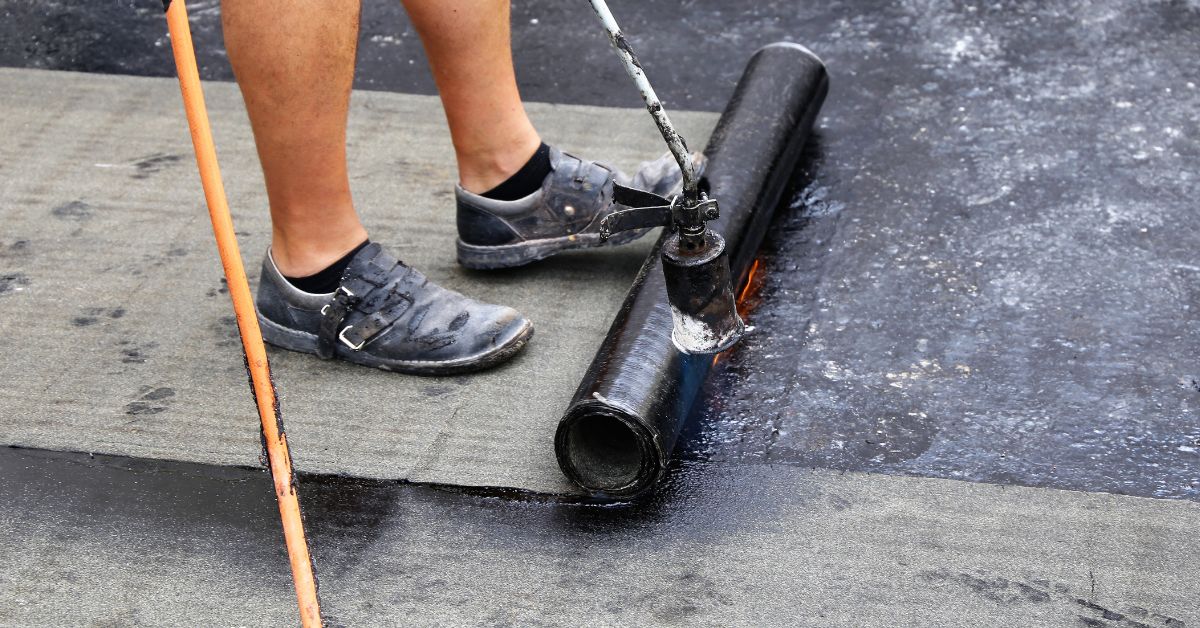 a roofer waterproofing flat roof